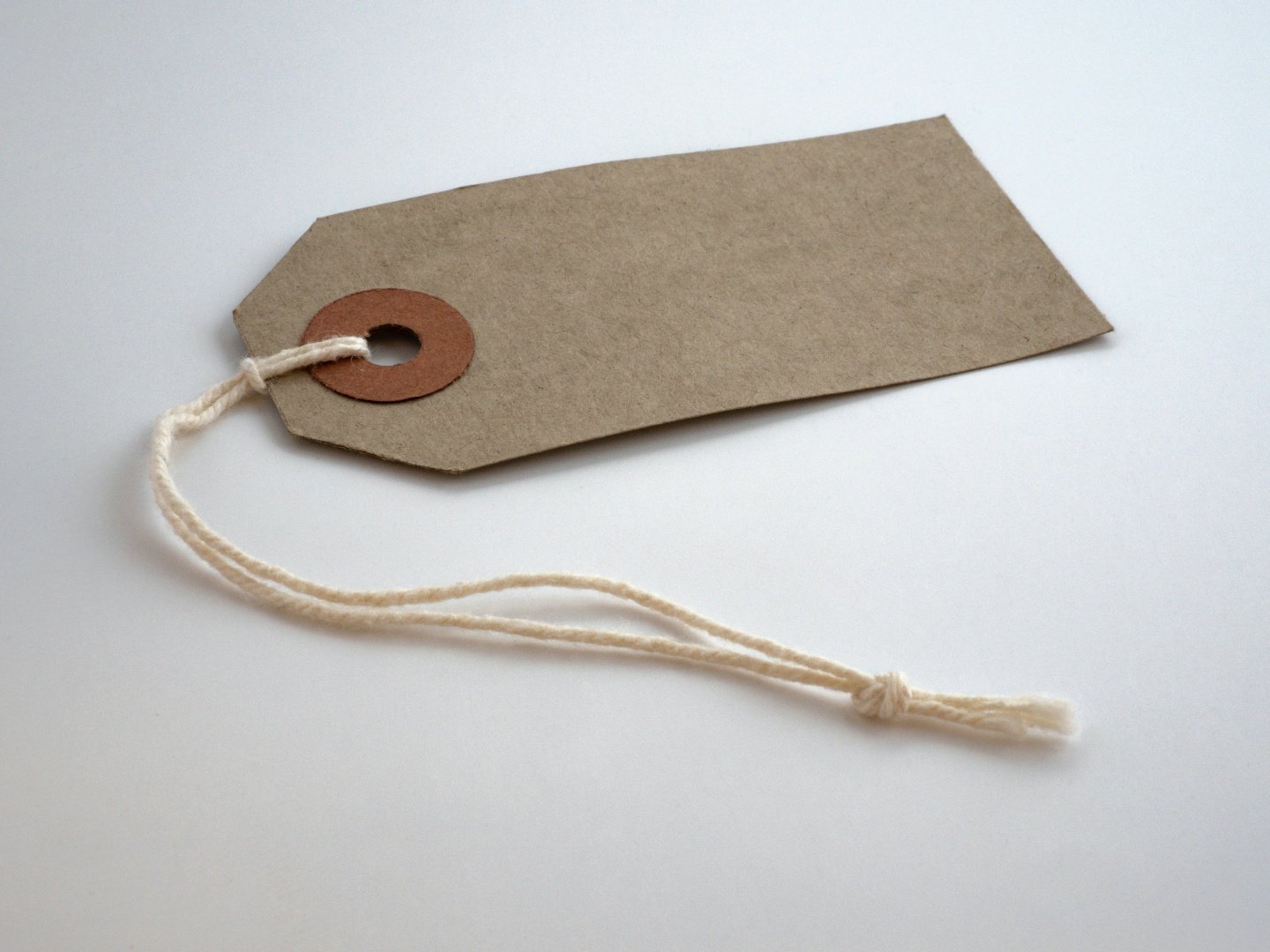 A blank, brown paper price tag sitting on a counter